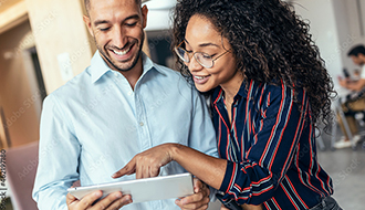 two sales and marketing reps look at ipad together