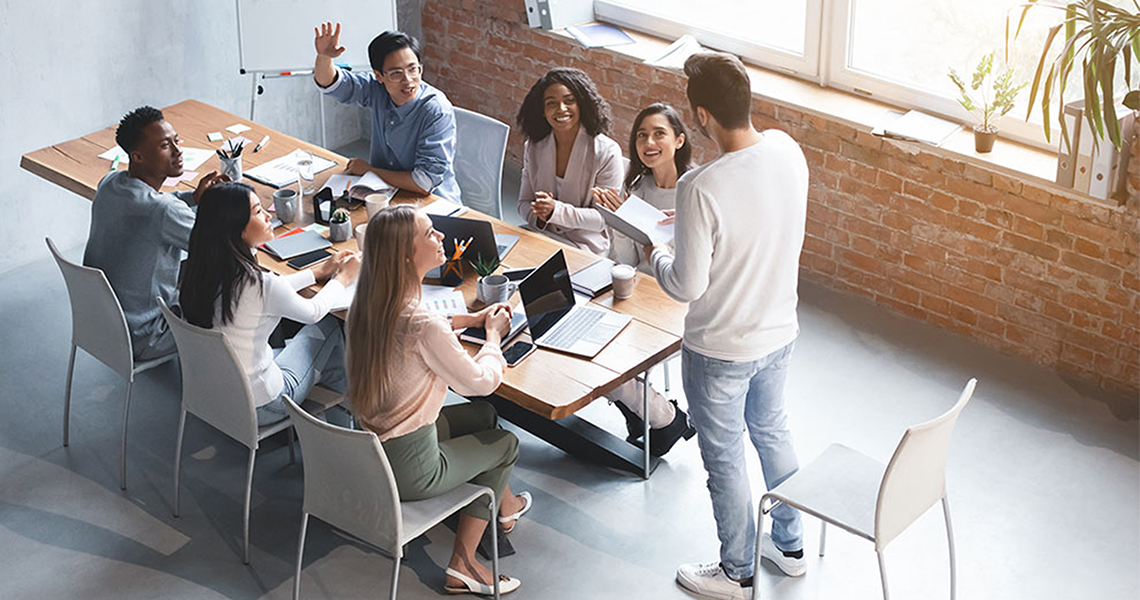 people from sales and marketing teams meet in a conference room