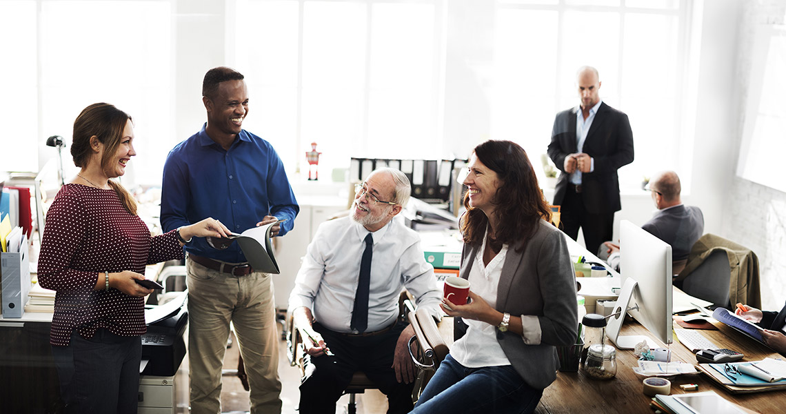 a happy sales team meets in an office