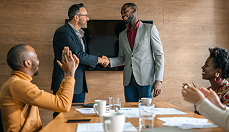 coworkers applauding leadership during a meeting